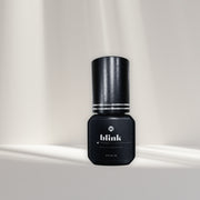 I AM Lash Professional Blink eyelash extension glue bottle showing black adhesive with applicator tip for eyelash extensions.