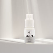 Sheer clear eyelash extension glue from I AM Lash Professional, showing the adhesive bottle used for eyelash extensions.