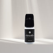 Touch Eyelash Extension Glue from I AM Lash Professional, a clear eyelash adhesive bottle with applicator tip.